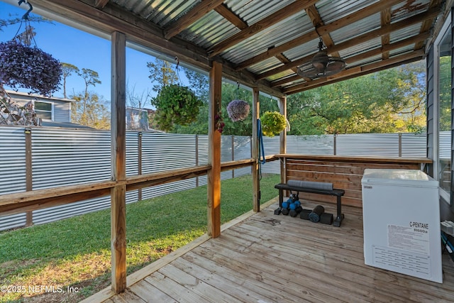 exterior space with a lawn, a fenced backyard, and ceiling fan