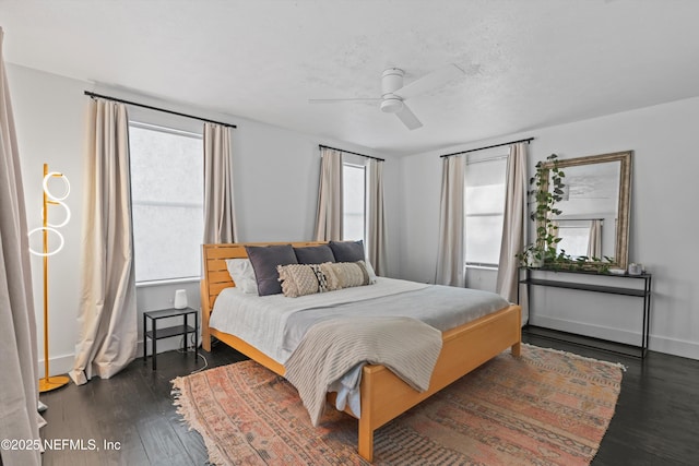 bedroom featuring baseboards, a ceiling fan, and wood finished floors