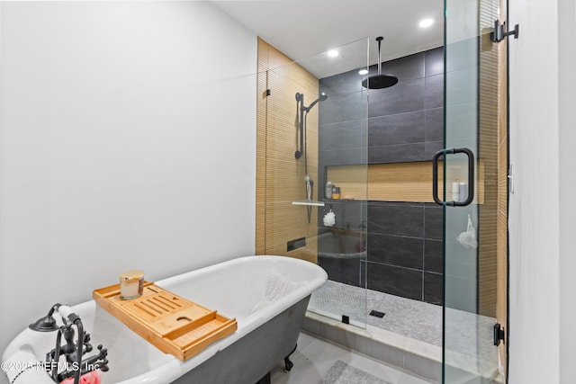 bathroom featuring recessed lighting, a soaking tub, and a stall shower