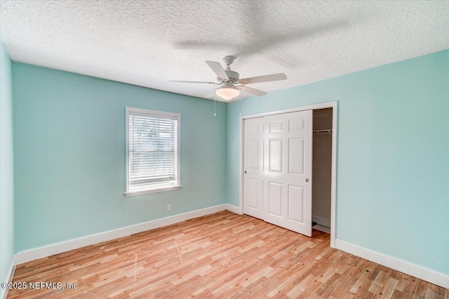 unfurnished bedroom with ceiling fan, a closet, baseboards, and wood finished floors