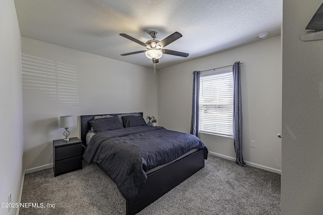 bedroom featuring a ceiling fan, baseboards, carpet floors, and a textured ceiling