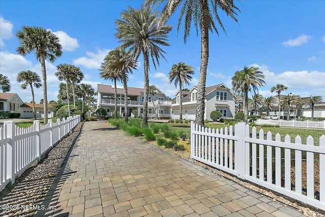 view of property's community featuring a residential view and a fenced front yard