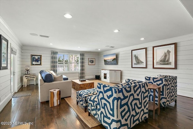 living area with crown molding, recessed lighting, wood finished floors, and visible vents