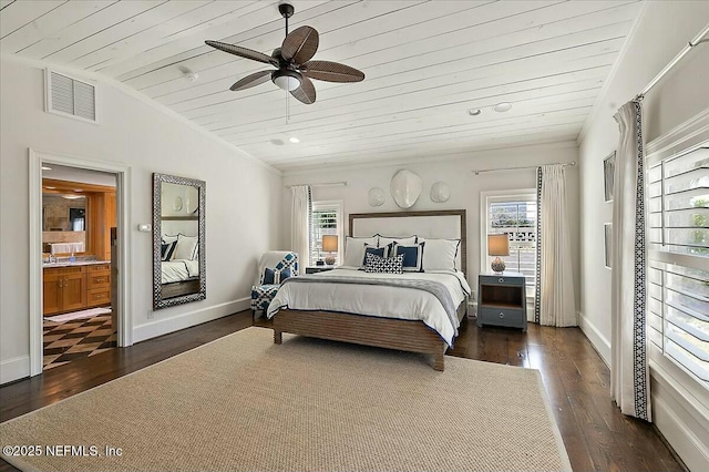 bedroom featuring visible vents, lofted ceiling, multiple windows, and wood finished floors