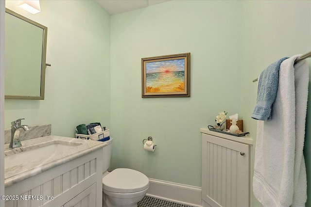 bathroom featuring visible vents, toilet, vanity, and baseboards