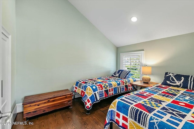 bedroom featuring vaulted ceiling and wood finished floors