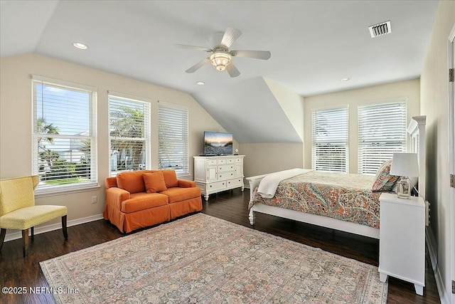 bedroom featuring dark wood finished floors, visible vents, baseboards, and vaulted ceiling