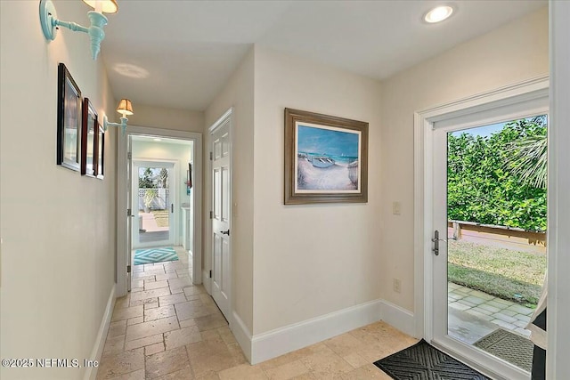 entryway featuring recessed lighting, baseboards, and stone tile flooring