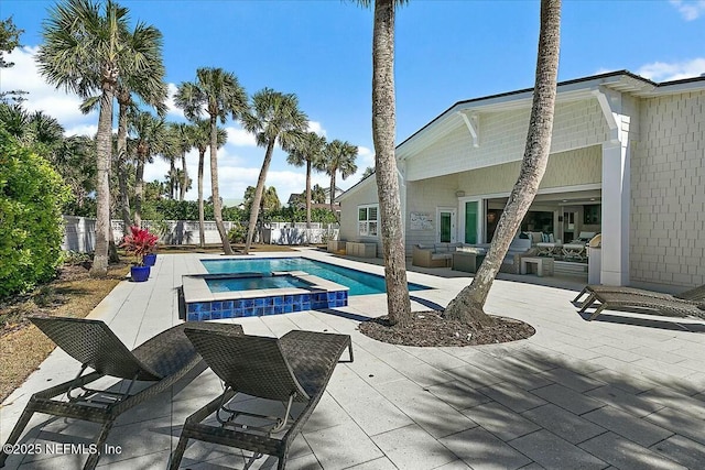 view of pool with a patio area, a fenced backyard, and a pool with connected hot tub