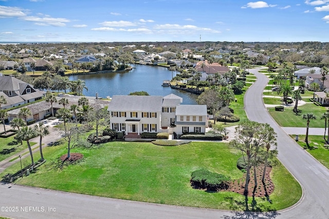 bird's eye view with a residential view and a water view