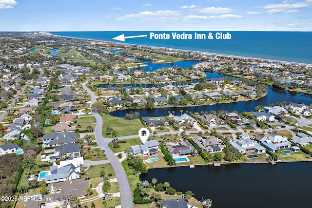 birds eye view of property with a water view and a residential view