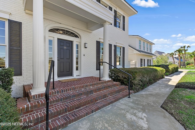 property entrance with brick siding and a residential view