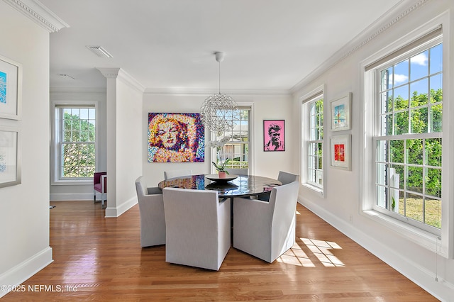 dining space featuring a chandelier, visible vents, light wood-type flooring, and ornamental molding