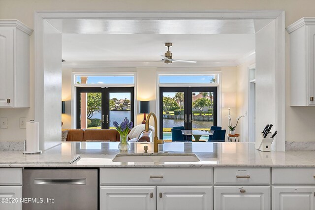 kitchen with a sink, french doors, crown molding, dishwasher, and a healthy amount of sunlight