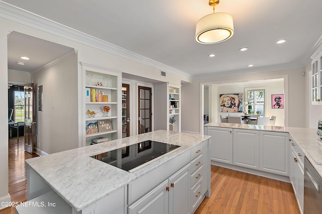 kitchen featuring light stone countertops, ornamental molding, light wood-style floors, white cabinetry, and black electric stovetop