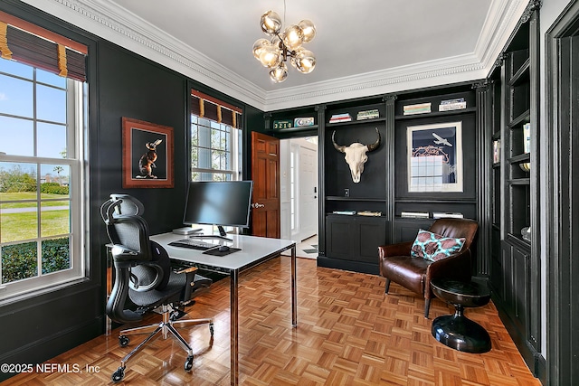 home office with plenty of natural light, an inviting chandelier, and ornamental molding