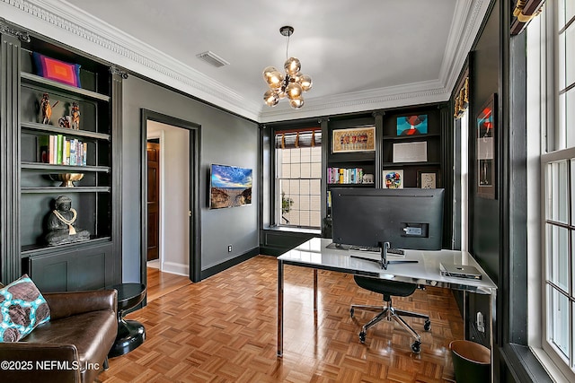 office space with a chandelier, baseboards, visible vents, and ornamental molding