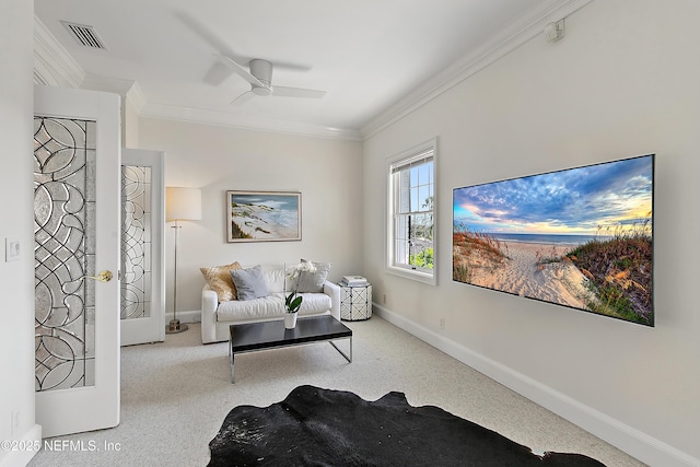 sitting room featuring visible vents, ornamental molding, carpet floors, baseboards, and ceiling fan