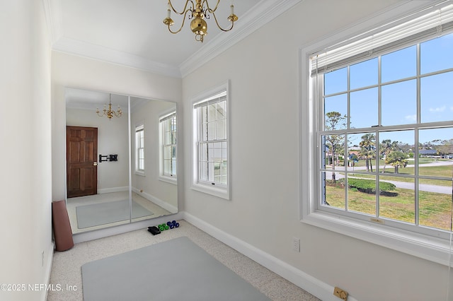 interior space featuring speckled floor, baseboards, plenty of natural light, and a chandelier