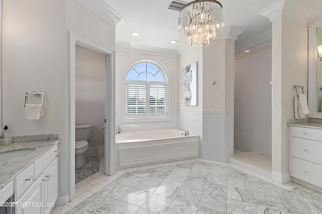 bathroom with vanity, crown molding, toilet, and a garden tub