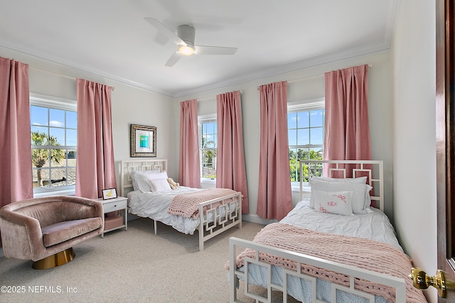 bedroom with a ceiling fan, carpet, and ornamental molding