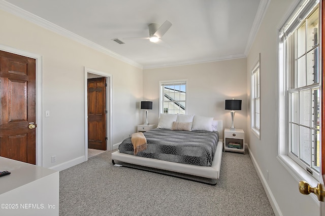 carpeted bedroom with ceiling fan, visible vents, baseboards, and ornamental molding