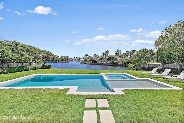 view of pool with fence, a lawn, a water view, and a pool with connected hot tub