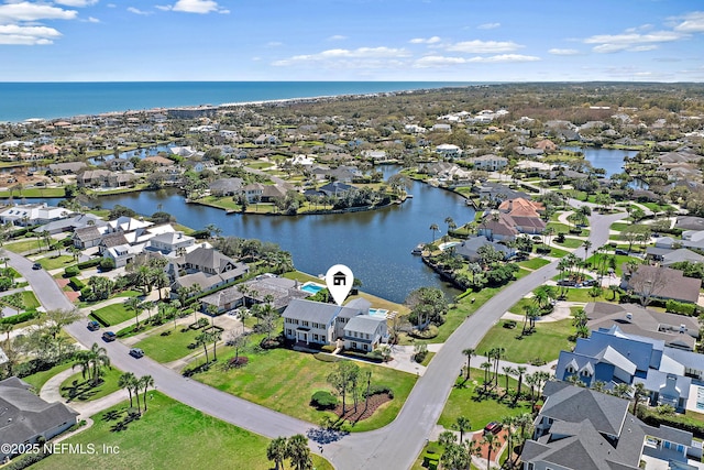 drone / aerial view featuring a residential view and a water view