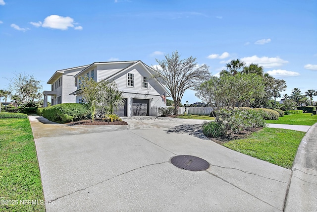 view of front of house featuring concrete driveway, an attached garage, and fence