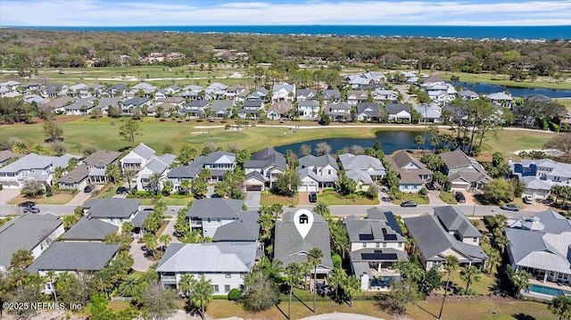 aerial view with a residential view, view of golf course, and a water view