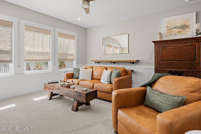 carpeted living room with recessed lighting and wainscoting