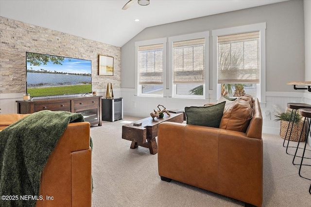 living room featuring plenty of natural light, carpet floors, and wainscoting