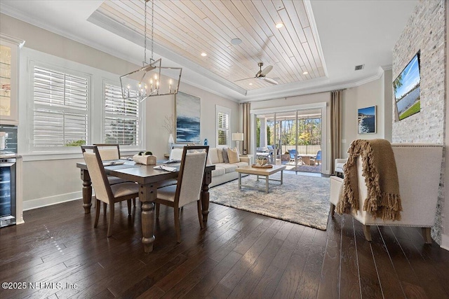 dining space with a tray ceiling, wooden ceiling, hardwood / wood-style floors, and crown molding