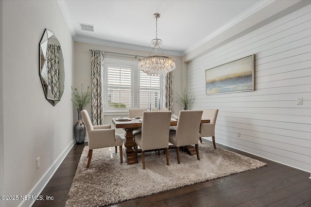 dining room with a notable chandelier, visible vents, dark wood-style flooring, and ornamental molding