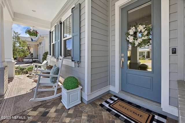 view of exterior entry featuring a porch