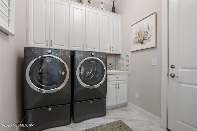 clothes washing area featuring marble finish floor, a sink, cabinet space, separate washer and dryer, and baseboards