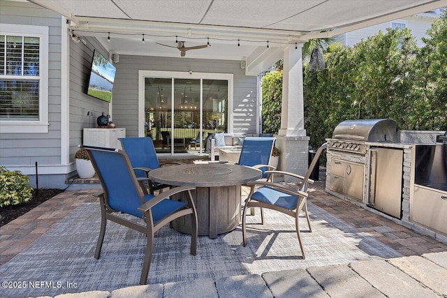 view of patio featuring a grill, exterior kitchen, and outdoor dining space