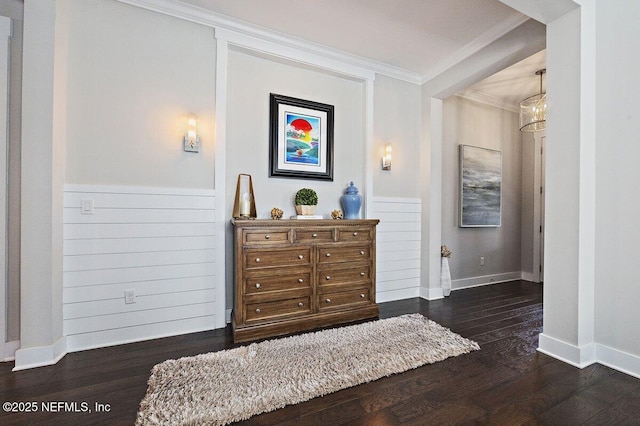 bedroom featuring wood finished floors, baseboards, and ornamental molding