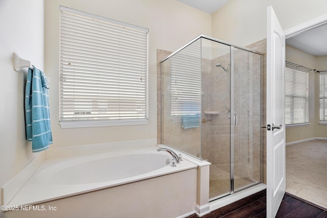 full bathroom featuring a stall shower and a bath