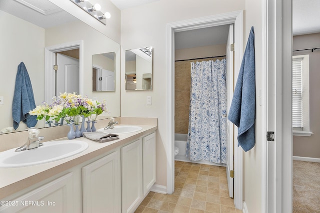 bathroom with double vanity, shower / bathtub combination with curtain, toilet, and a sink