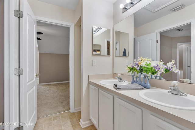 bathroom featuring double vanity, visible vents, and a sink