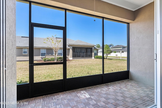 unfurnished sunroom with a residential view