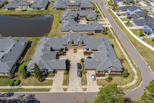 aerial view with a residential view and a water view