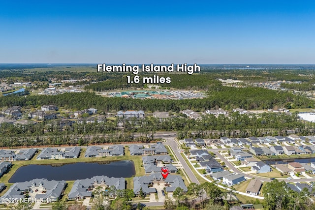 drone / aerial view featuring a residential view and a water view