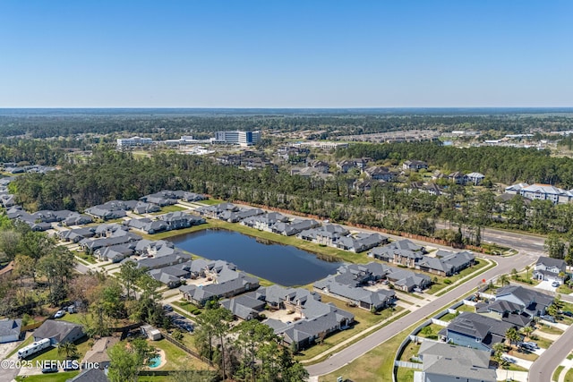 drone / aerial view with a residential view and a water view