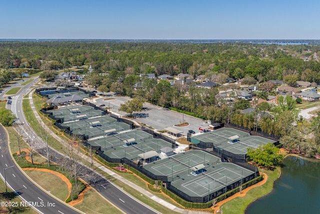 aerial view with a residential view, a view of trees, and a water view