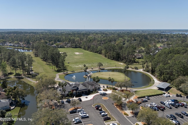 birds eye view of property with golf course view, a forest view, and a water view