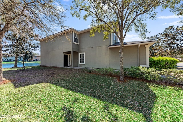 rear view of house with a lawn