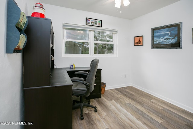 office space featuring ceiling fan, baseboards, and wood finished floors