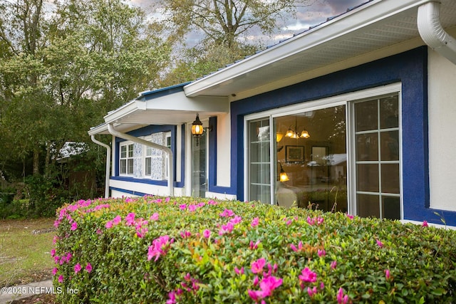 entrance to property featuring stucco siding